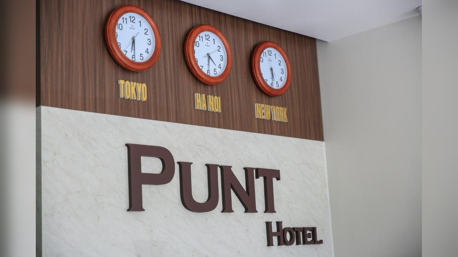 Lối vào Punt Hotel sử dụng kính lớn và bảng hiệu rõ ràng, phù hợp khách sạn mặt tiền phố.