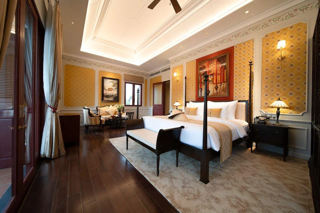 Màu vàng đất, xanh lam, tranh nghệ thuật và gỗ tối tạo một căn phòng trang trọng nhưng vẫn ấm.