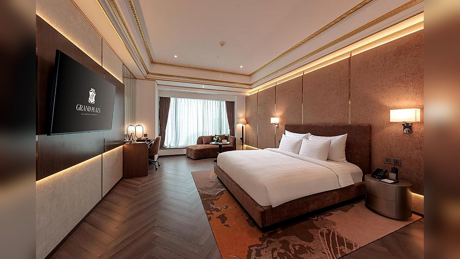 Phòng deluxe ấm áp với nội thất bọc nệm và ánh sáng dịu, phù hợp phong cách tân cổ điển.